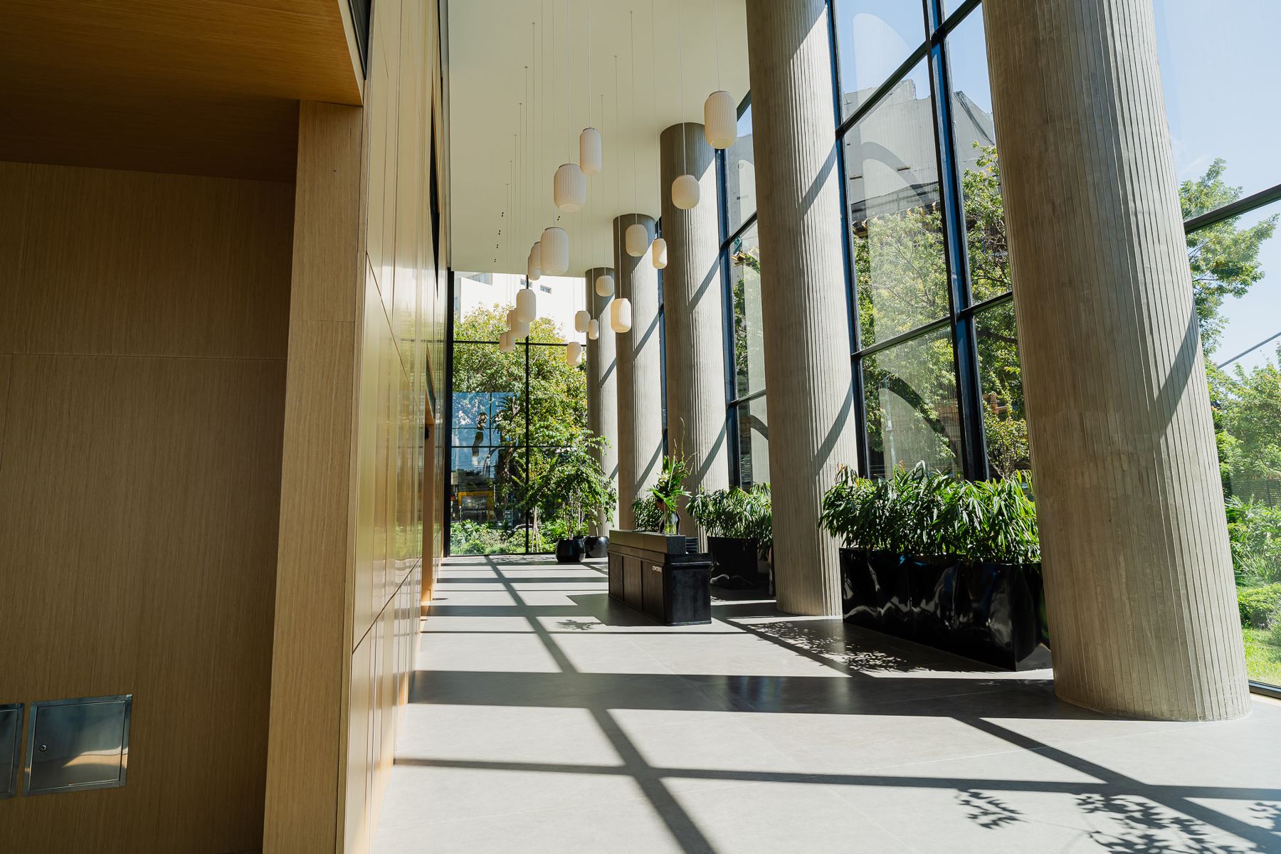 Galería vidriada con columnas y jardín interior